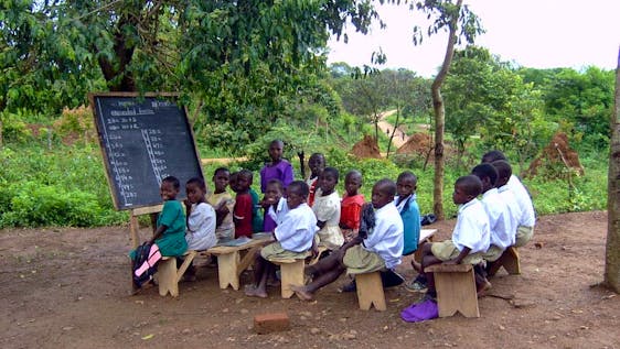 School in session in a rural setting under a tree