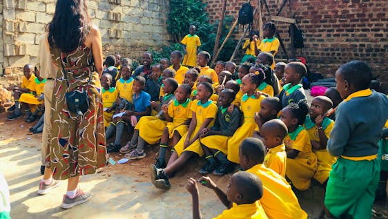 Volunteer in Uganda Teaching Baby Class and Primary School
