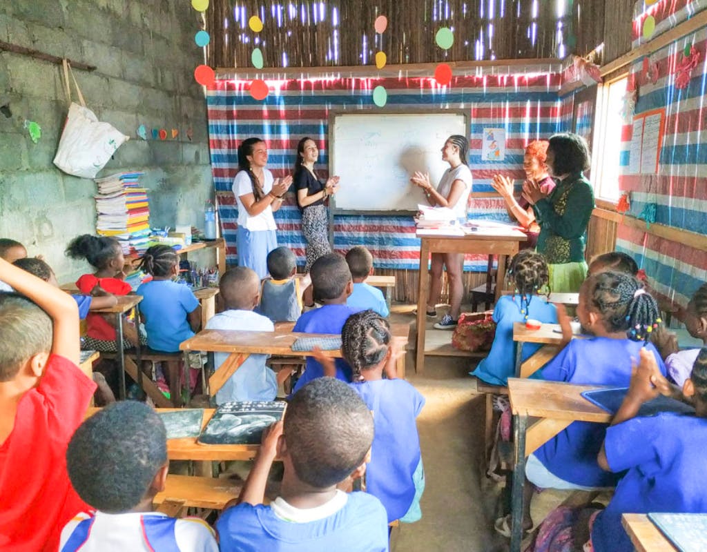 volunteers in fornt of class