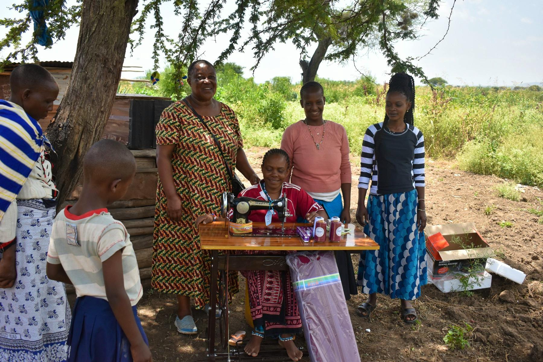 Mama Hokororo with a tailoring graduate when they brought a sewing machine donated by a volunteer 