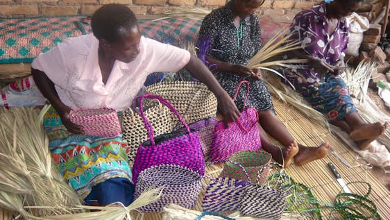 Women making craft hand bags from local material
