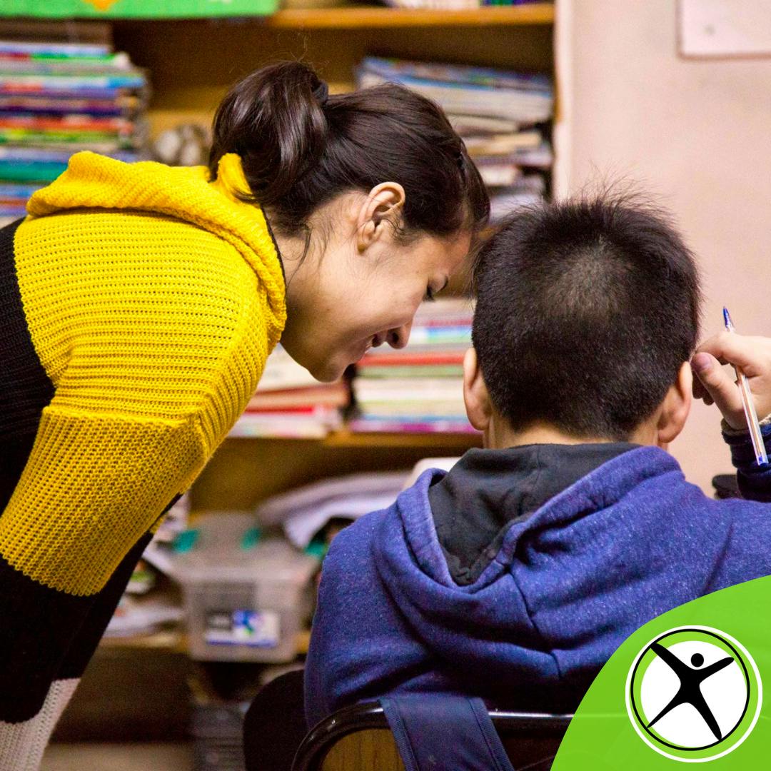 Volunteers and children understanding.