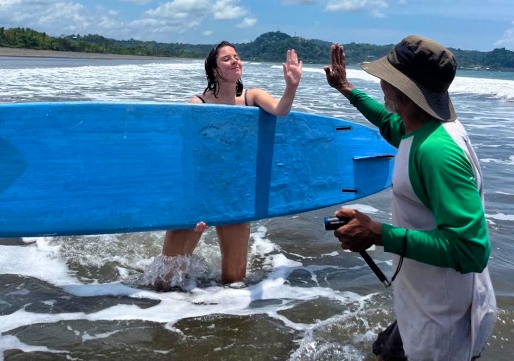 volunteers learning surf in a sea turtle project