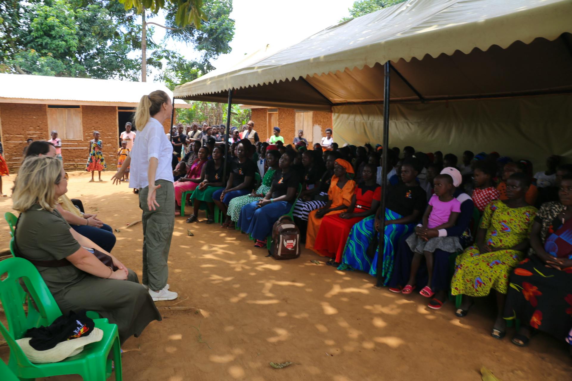 Jo from Australia motivating women in the community meeting on how to create their own  small business 