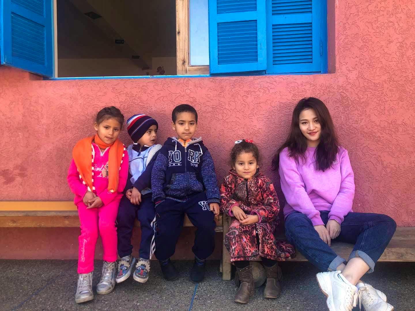 The volunteer Ellen with some of the kids she is entertaining in one of our childcare project in Rabat's Neighborhood. 