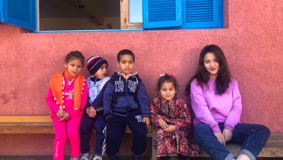 The volunteer Ellen with some of the kids she is entertaining in one of our childcare project in Rabat's Neighborhood. 